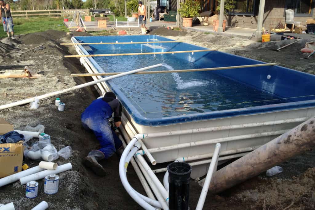 Fibreglass pools being installed in the ground