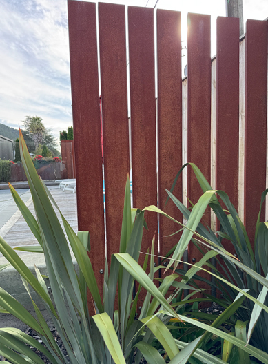 Pool fencing regulations example with vertical privacy screening beside a pool area